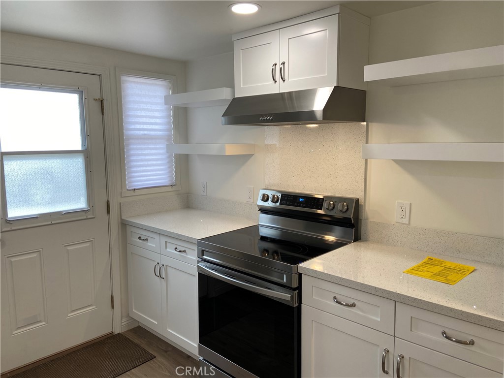 a kitchen with a stove and a microwave