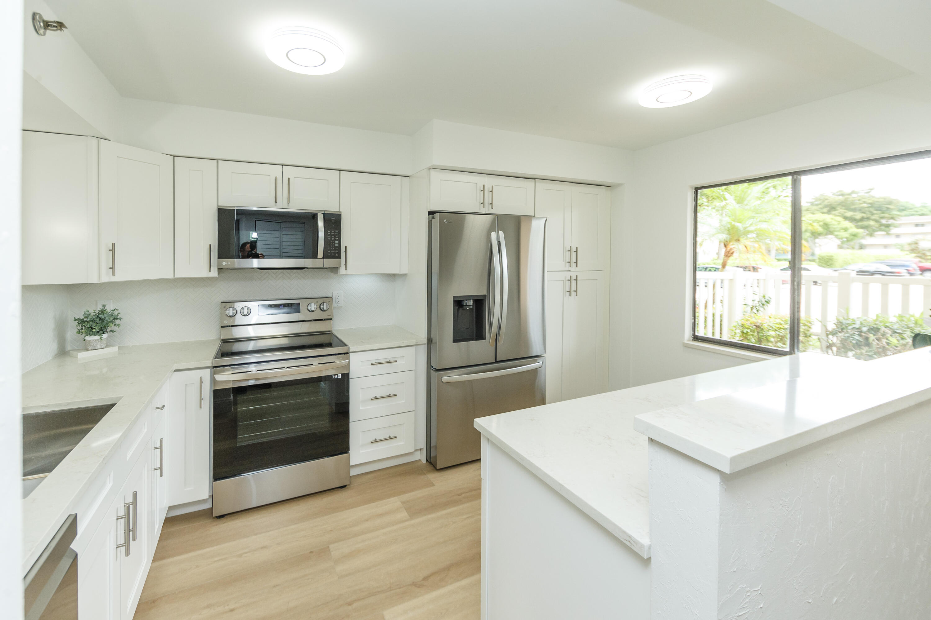 a kitchen with stainless steel appliances a stove microwave and refrigerator