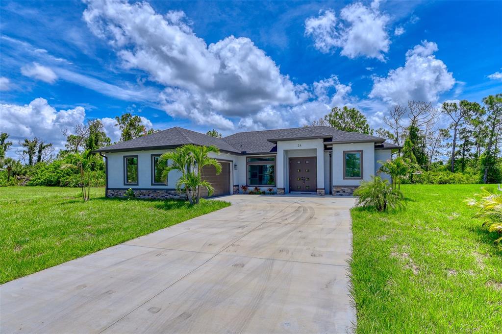 a front view of house with yard and green space