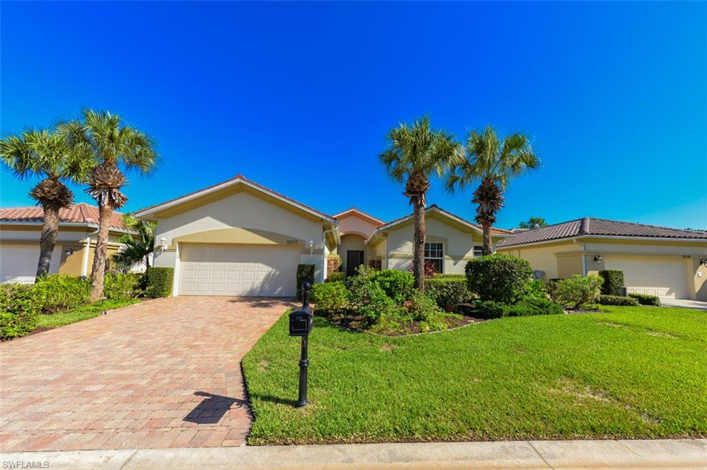 View of front of property featuring a garage and a front yard