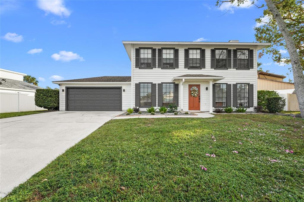 a front view of a house with a yard and garage