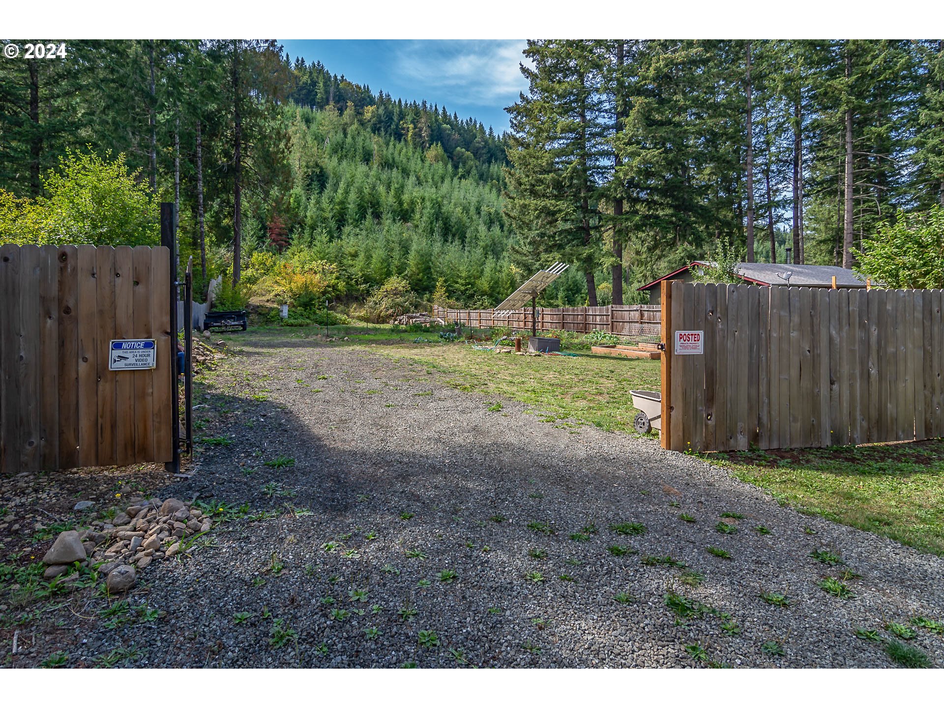 a view of a backyard with wooden fence