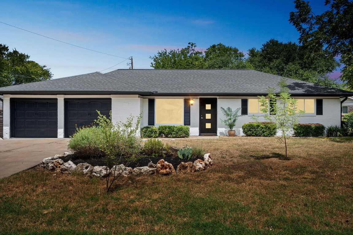 a front view of a house with a garden