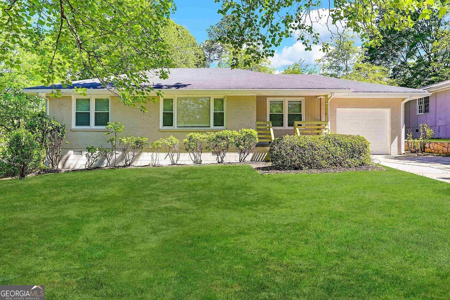 a front view of a house with a garden