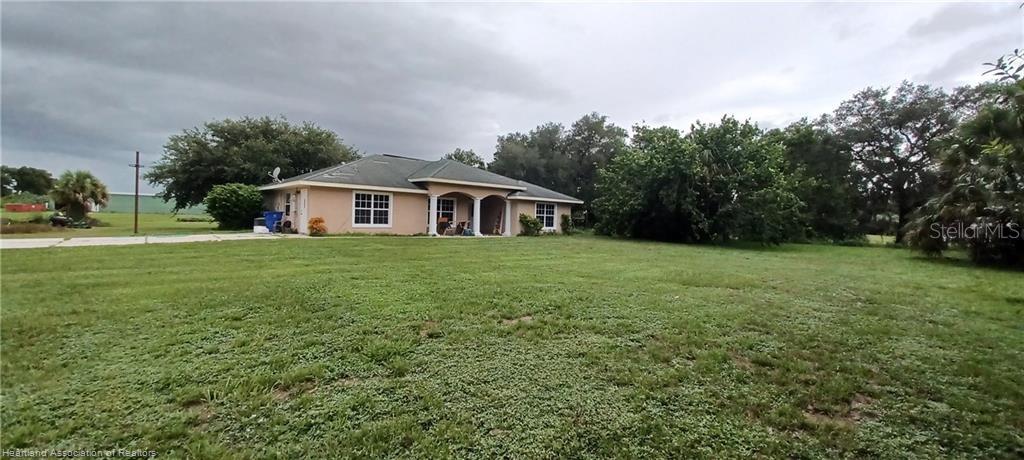 a view of a house with a yard and sitting area