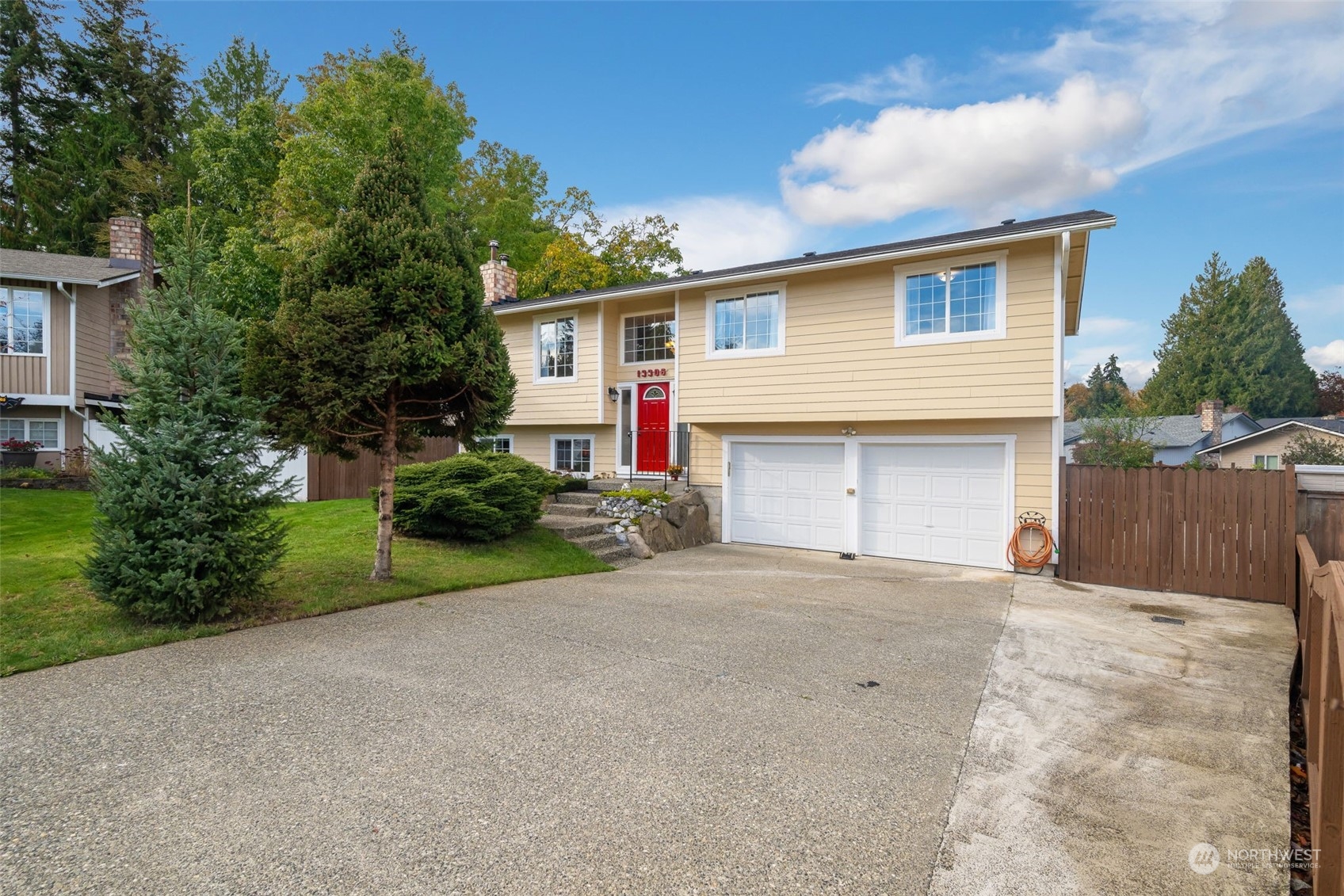 a view of a house with a yard and garage