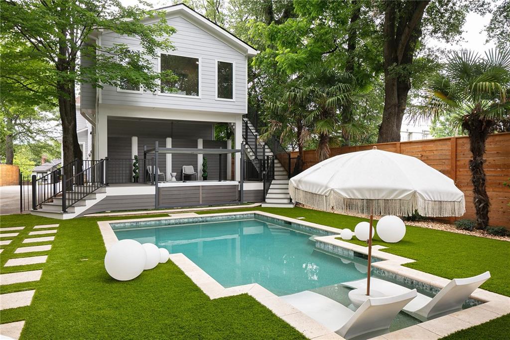 a swimming pool with barbeque oven and outdoor seating