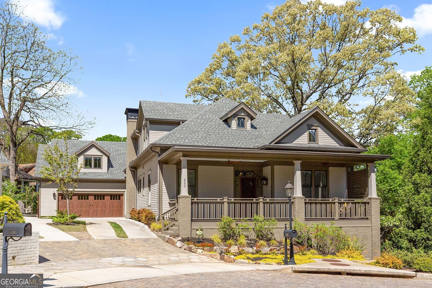 a front view of a house with a garden