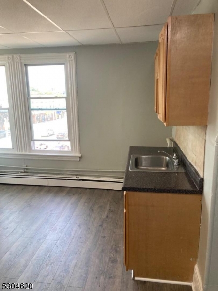 a bathroom with a granite countertop sink and a window