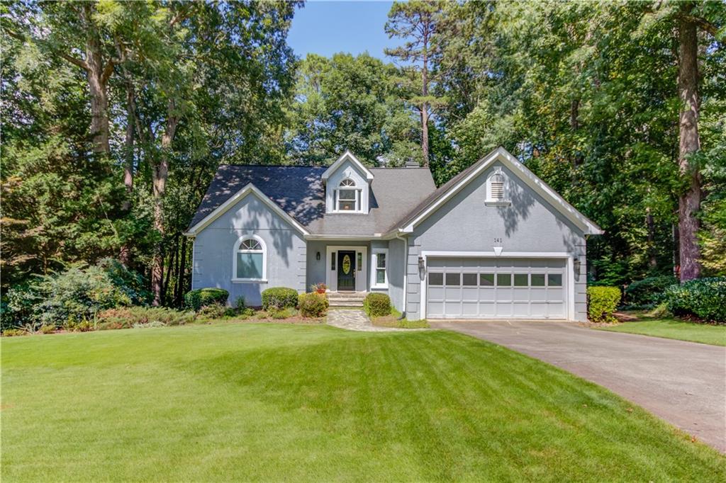 a front view of a house with garden