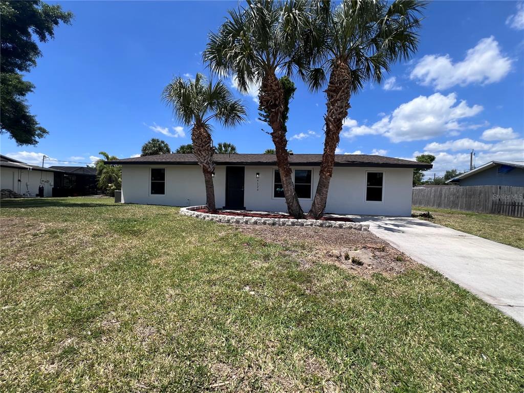 a view of a house with a yard and a garage