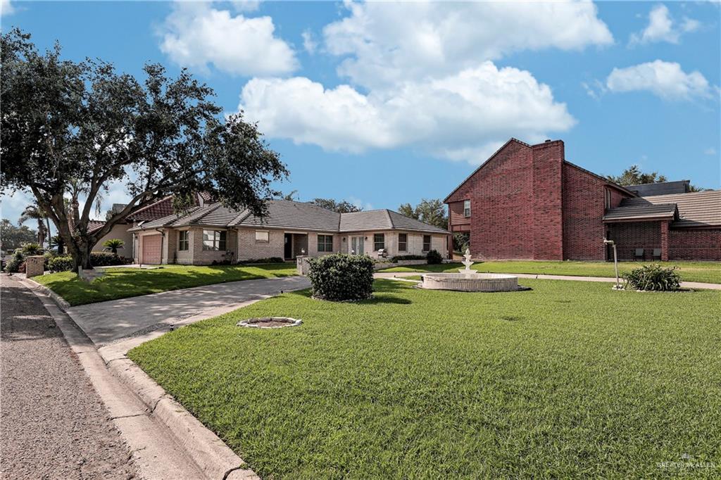 Ranch-style house featuring a front lawn