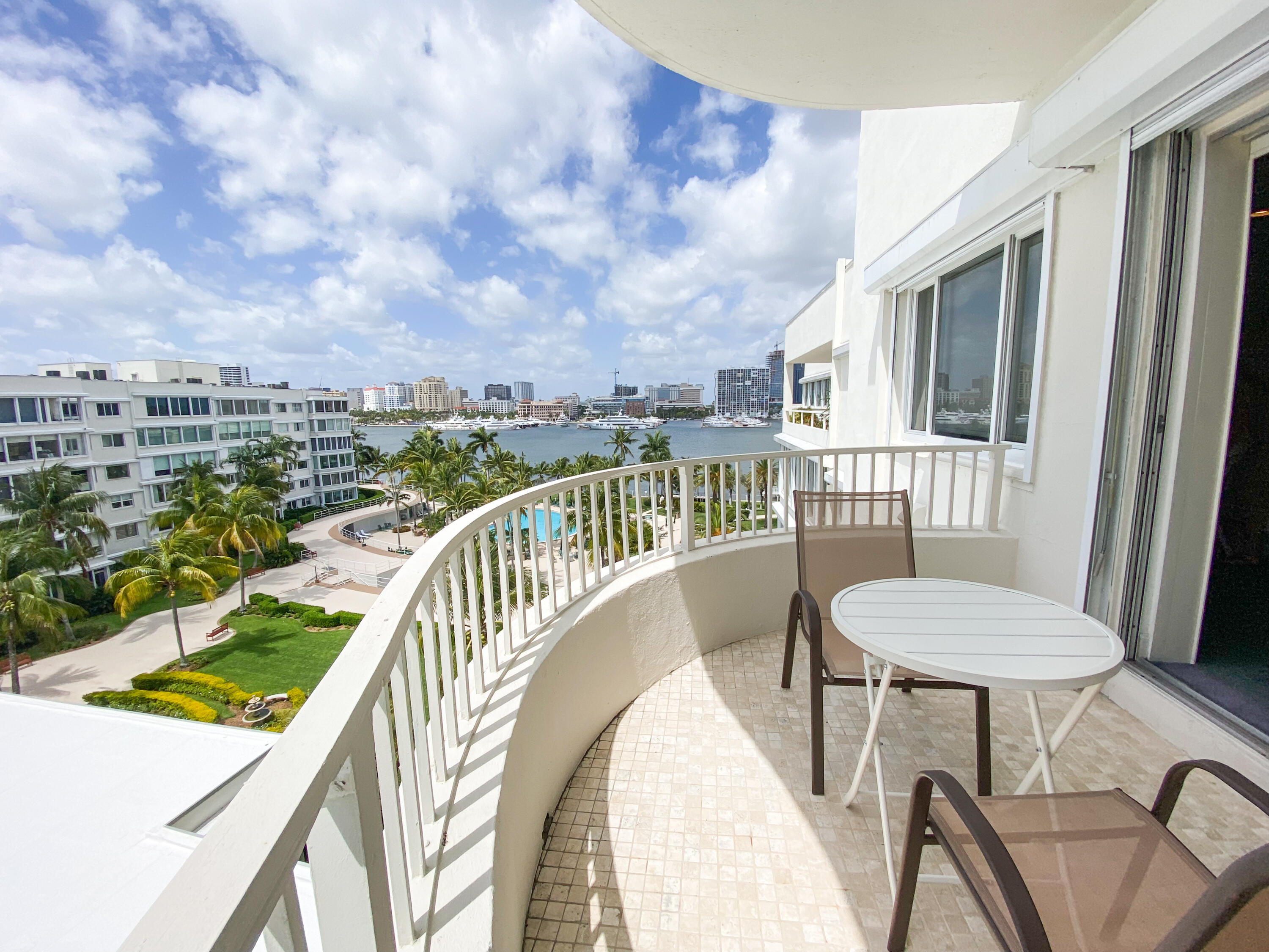 a balcony with table and chairs