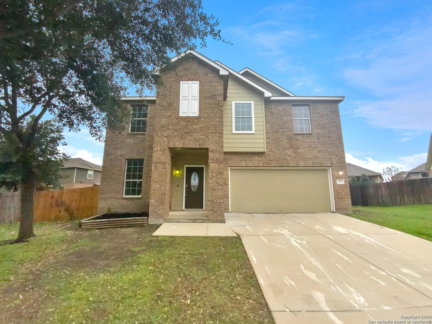 a front view of a house with a yard and garage