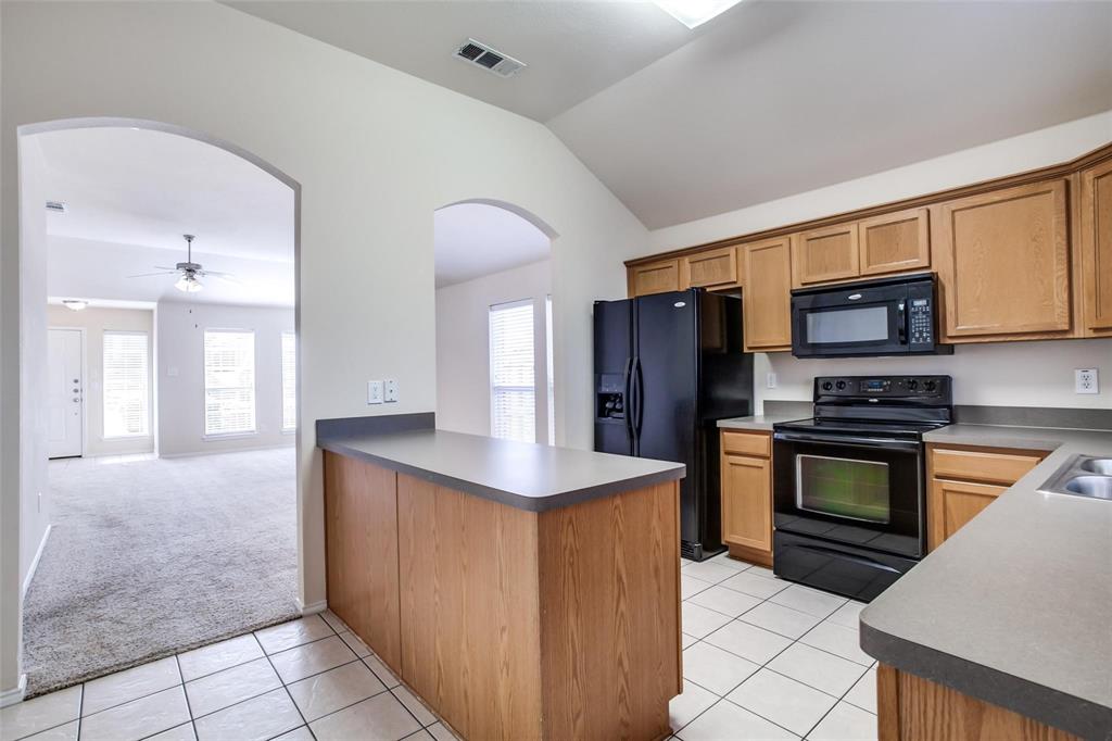 a kitchen with stainless steel appliances granite countertop a refrigerator stove and sink