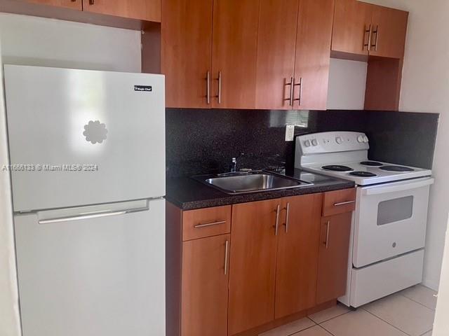 a kitchen with stainless steel appliances a refrigerator and a stove