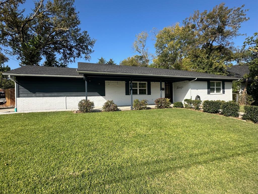 a front view of house with yard and outdoor seating