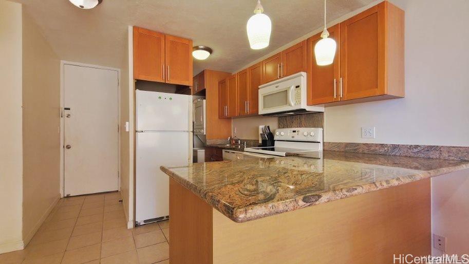 a kitchen with stainless steel appliances granite countertop a sink refrigerator and microwave