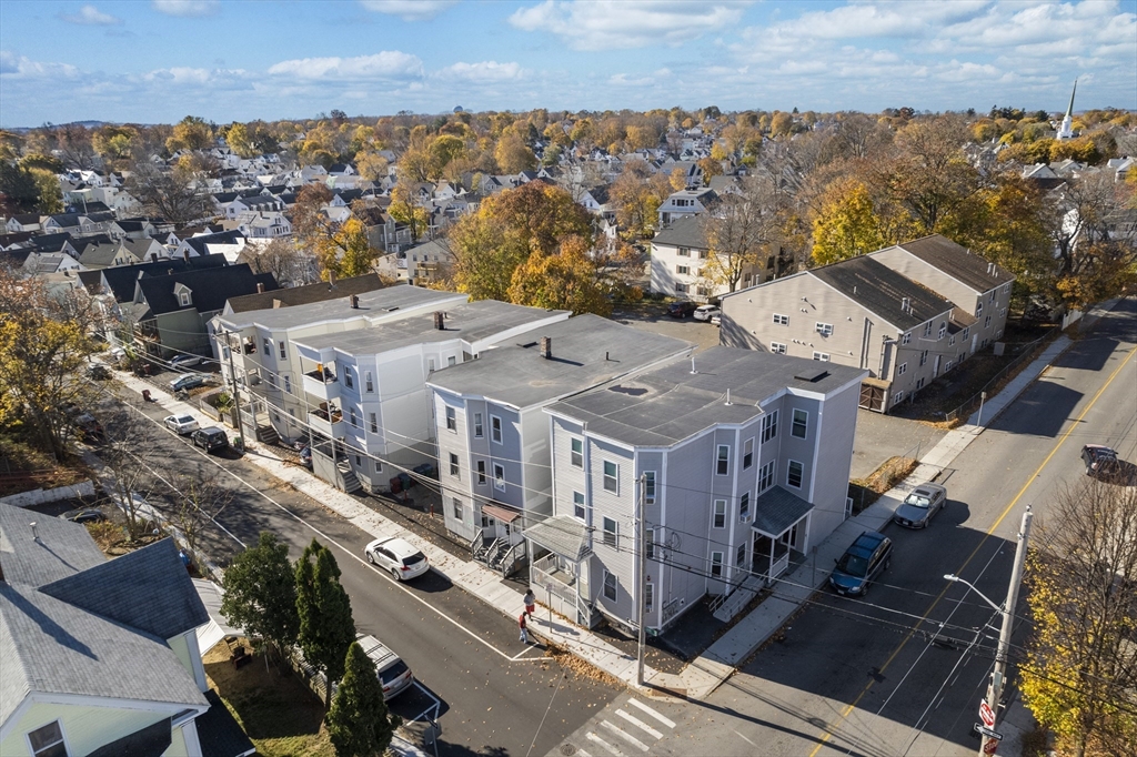 an aerial view of a residential apartment building with a yard