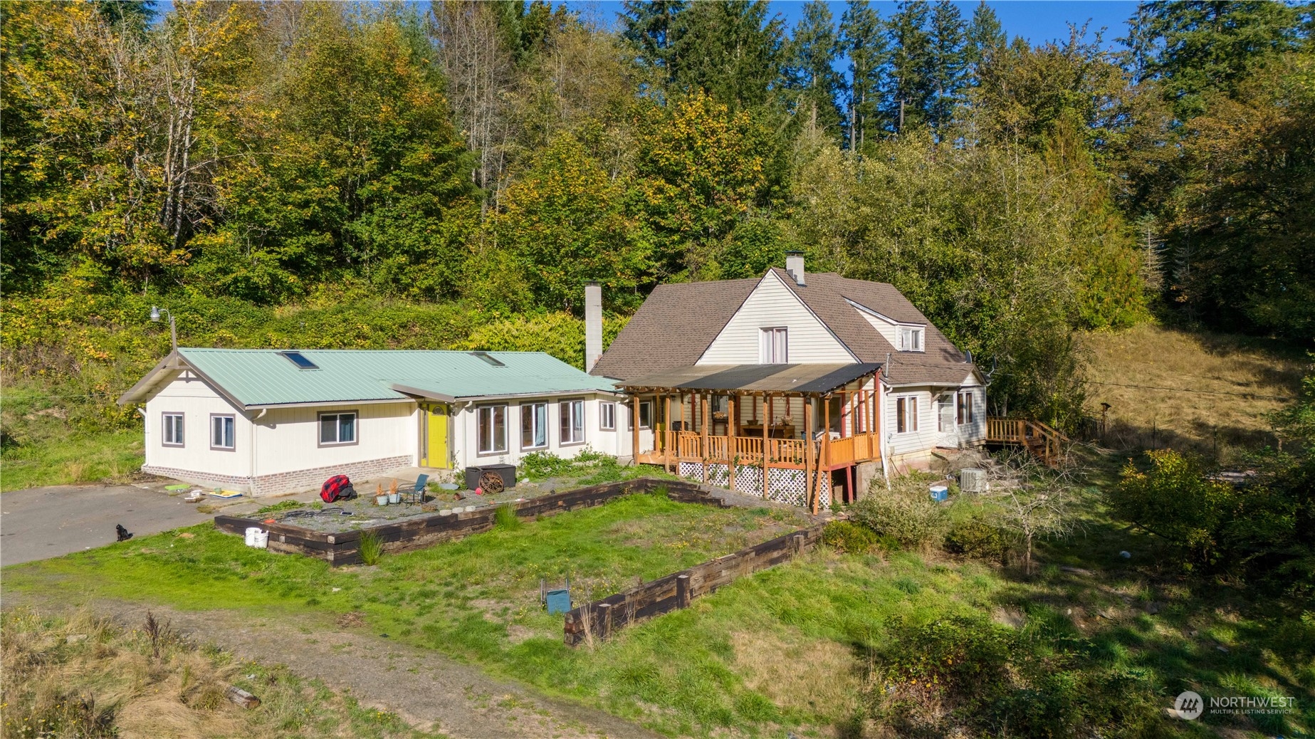 an aerial view of a house with yard and green space