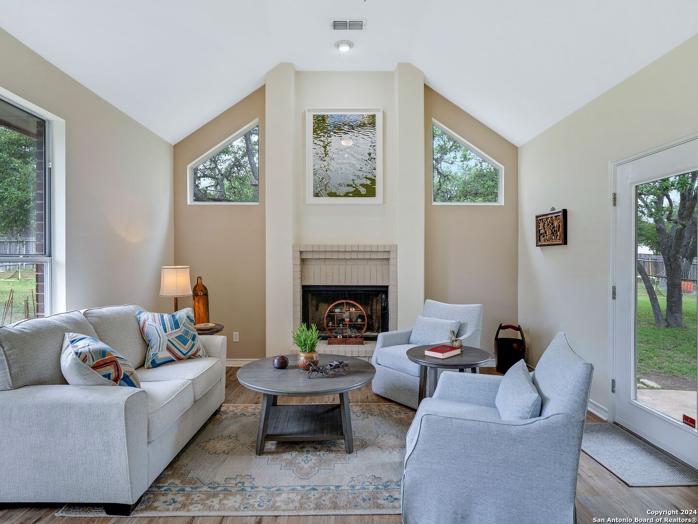 a living room with furniture and a fireplace