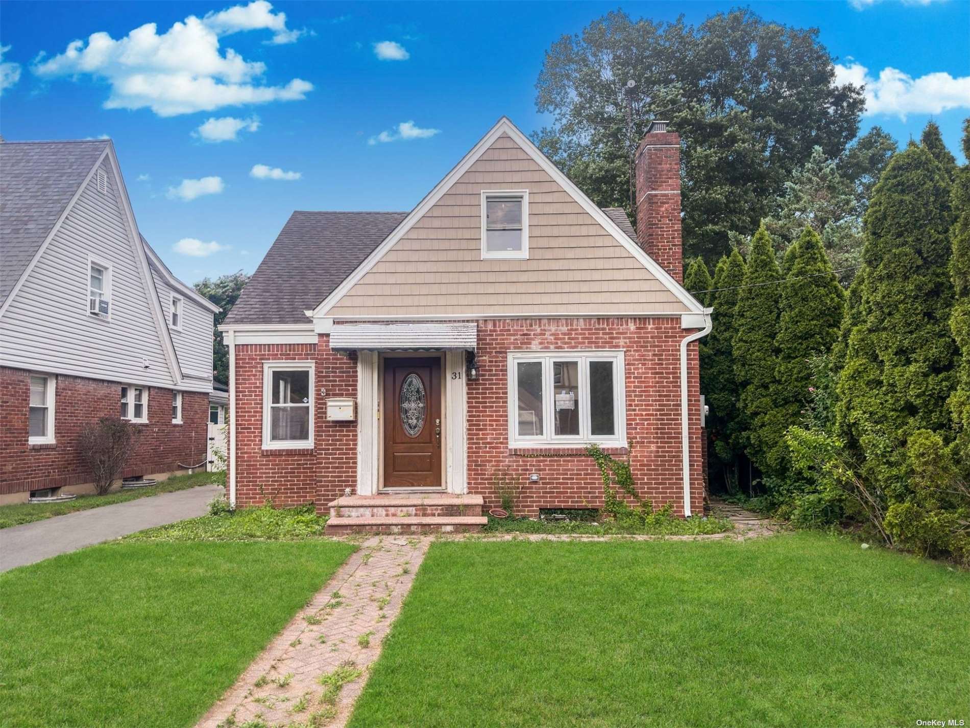 a front view of a house with a garden and yard