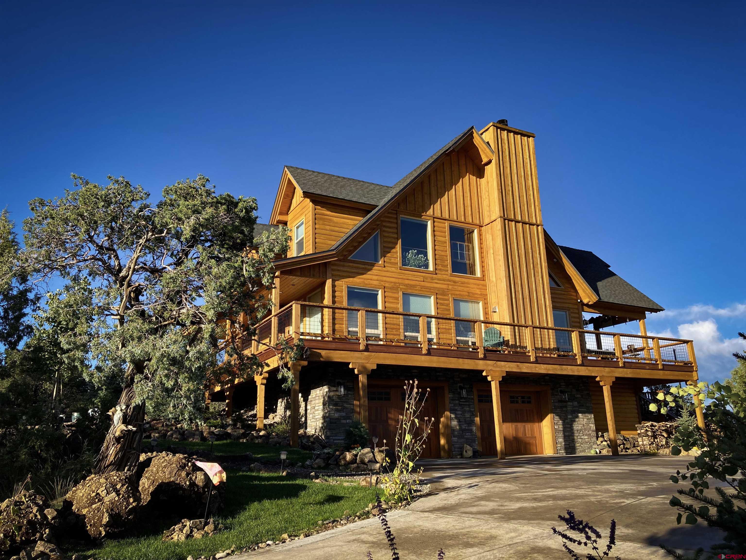 a view of a large building with large trees and playing area