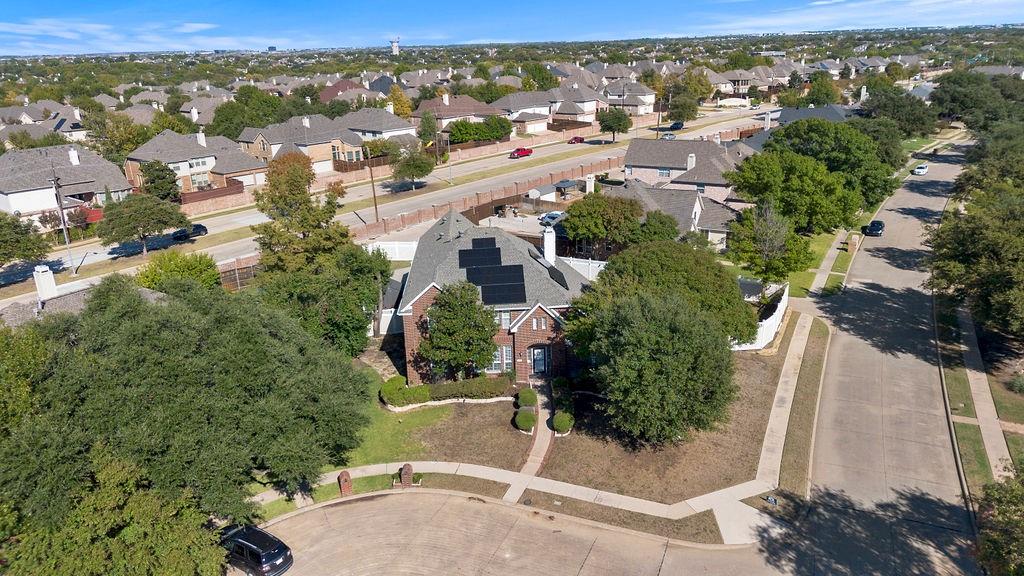 an aerial view of residential houses with outdoor space