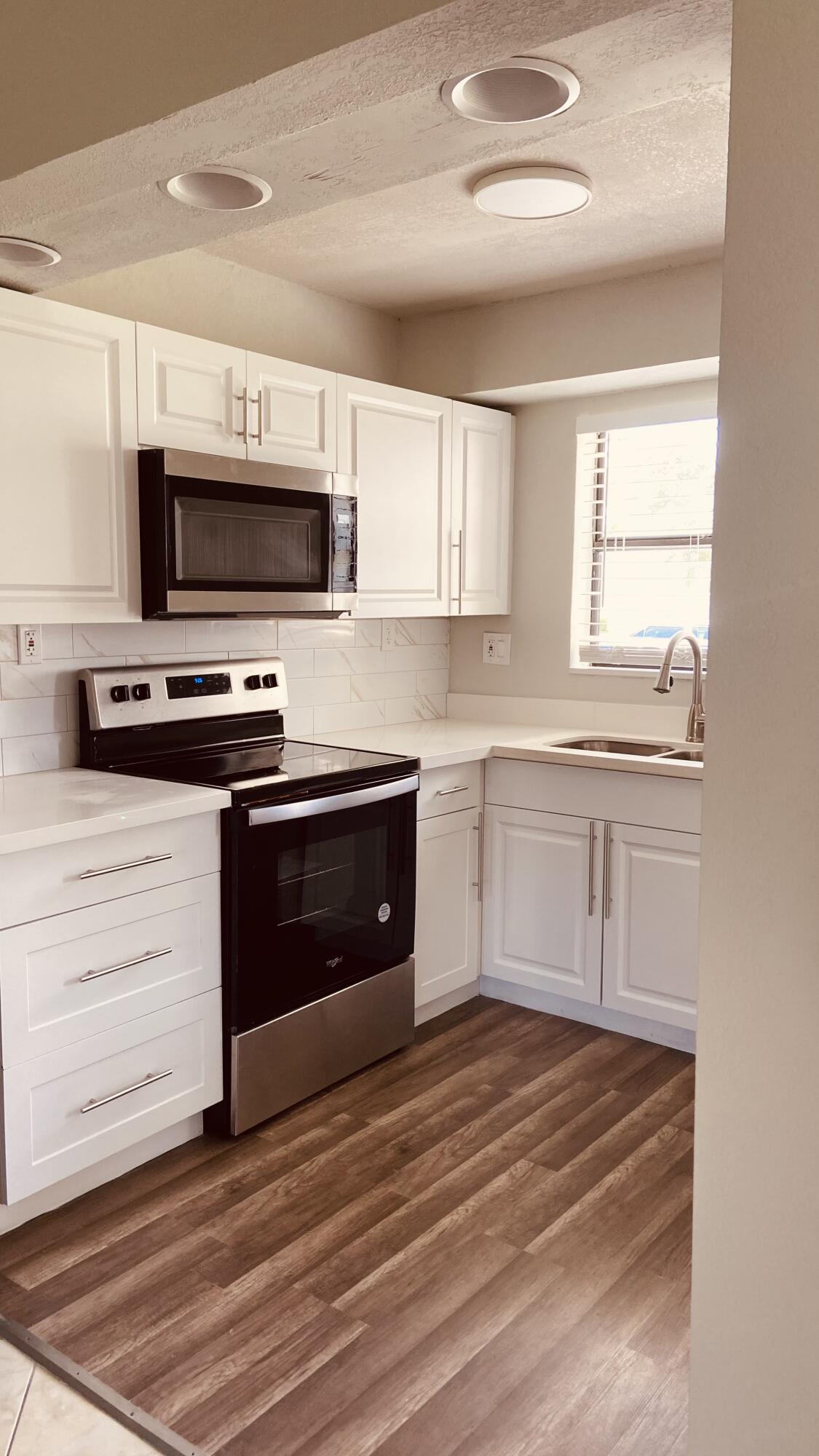 a kitchen with a stove microwave and a sink