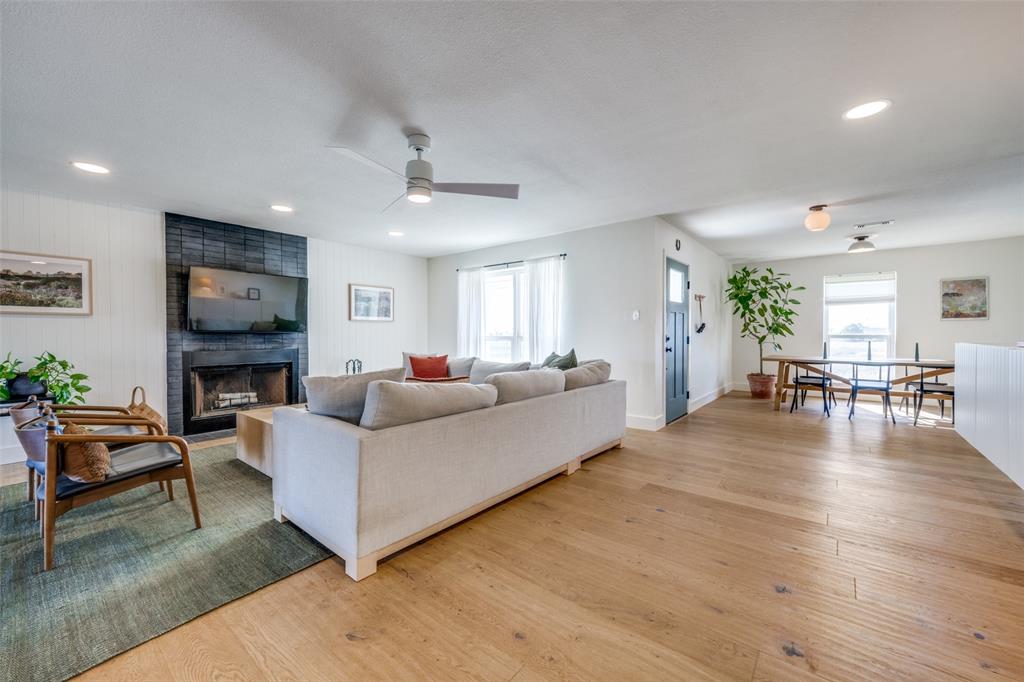 a living room with furniture wooden floor and a fireplace