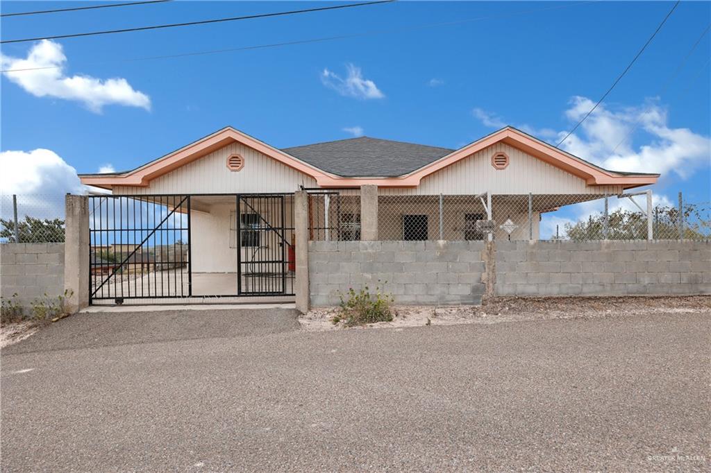 View of front of property and concrete fence