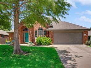 a front view of a house with a garden and yard