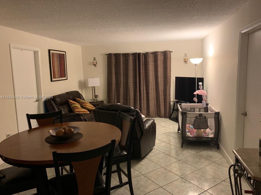 a living room with furniture a rug and a lamp