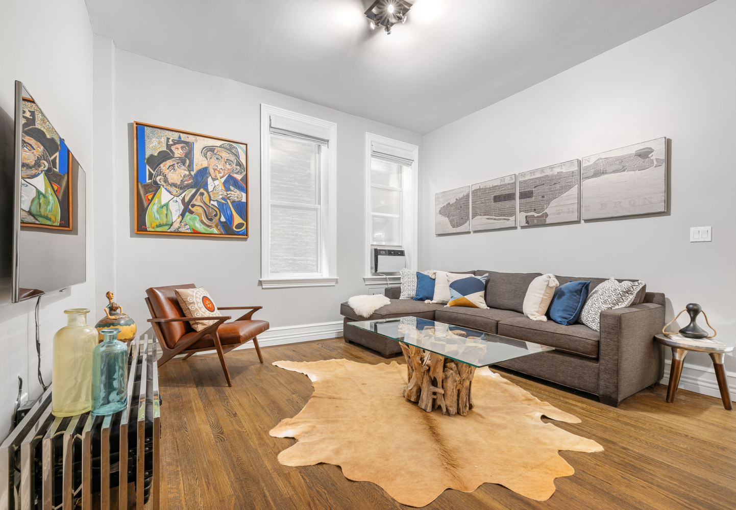 a living room with furniture and wooden floor