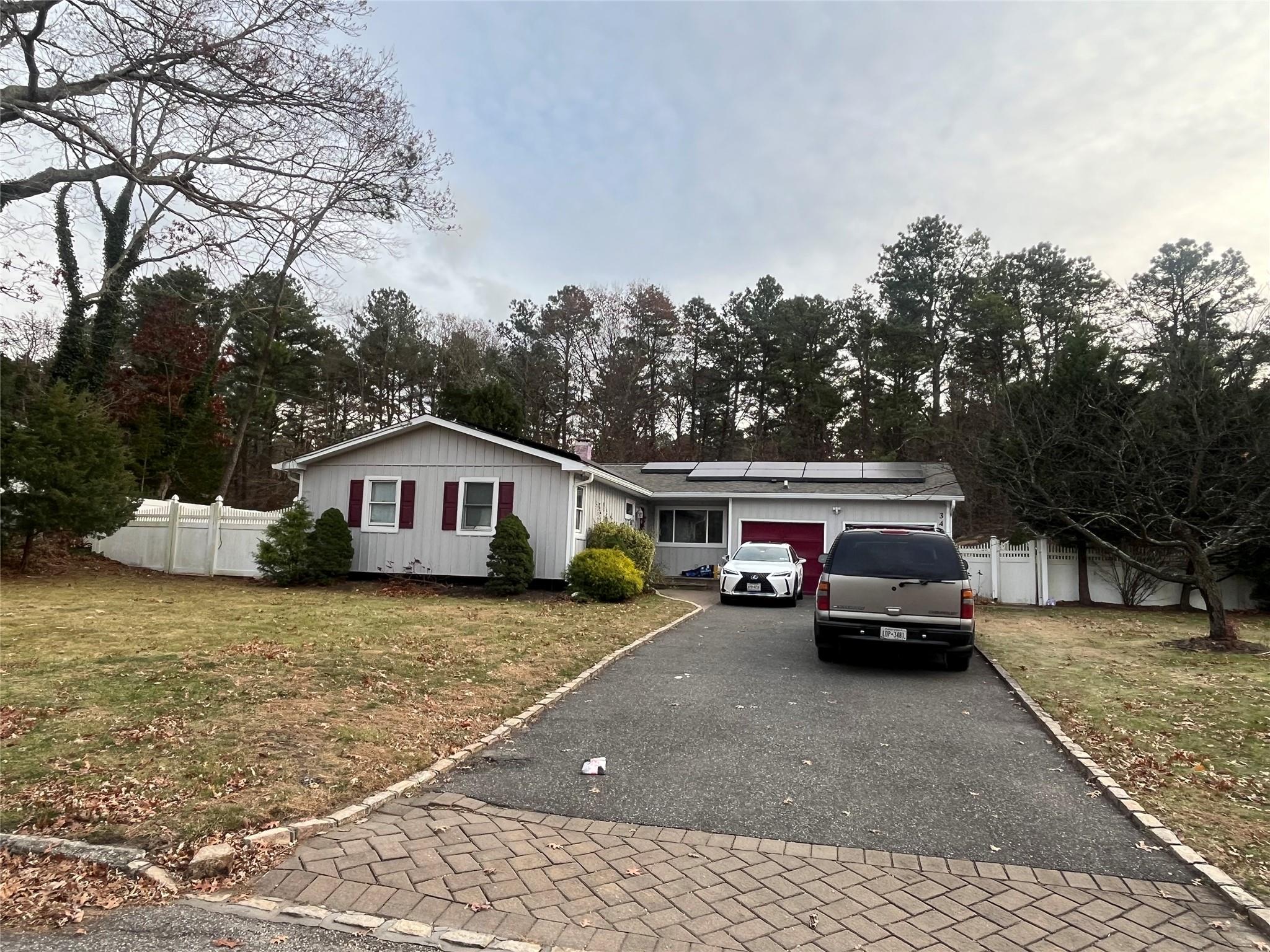 View of front facade with solar panels and a front yard