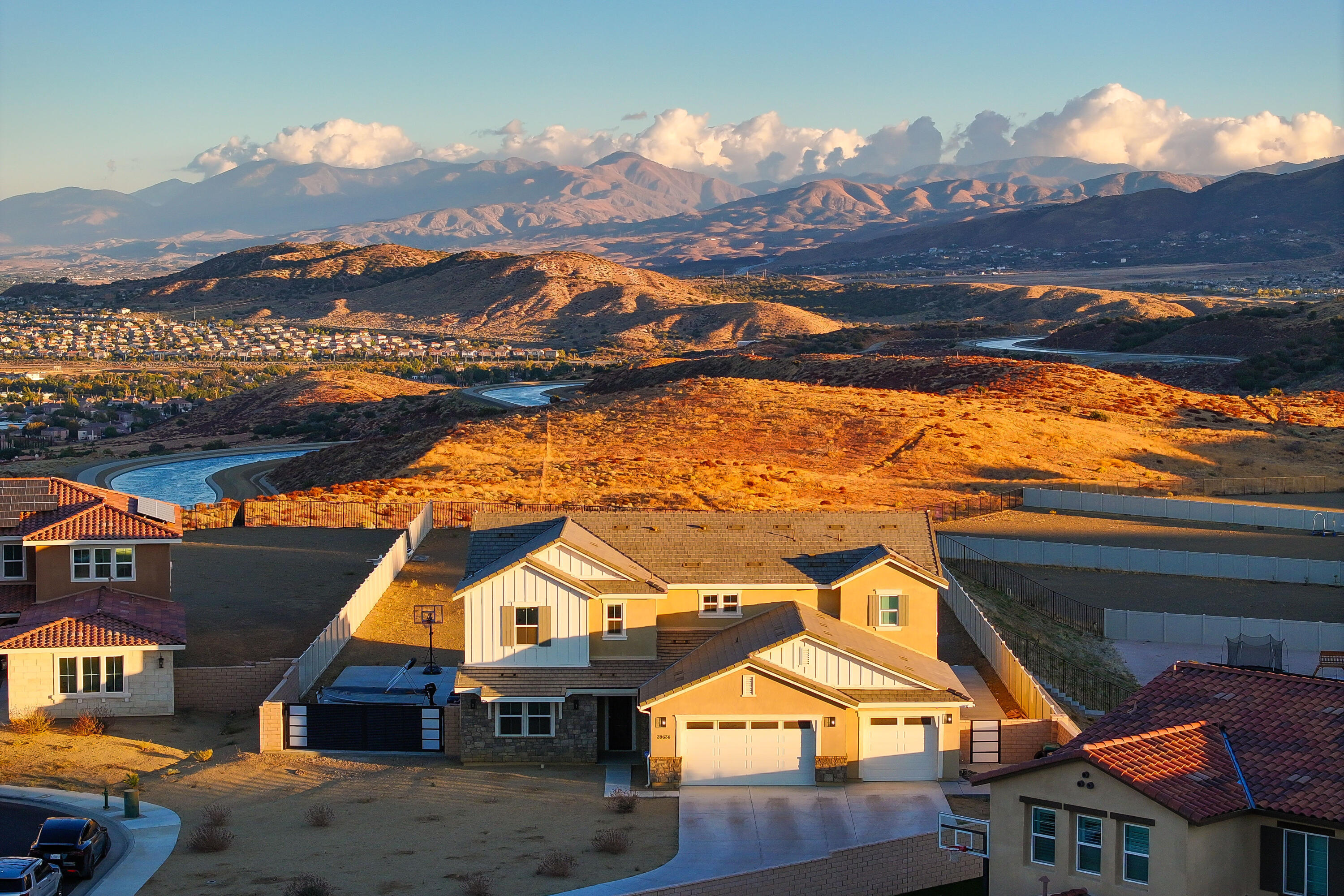 a front view of a house with a yard and mountain view