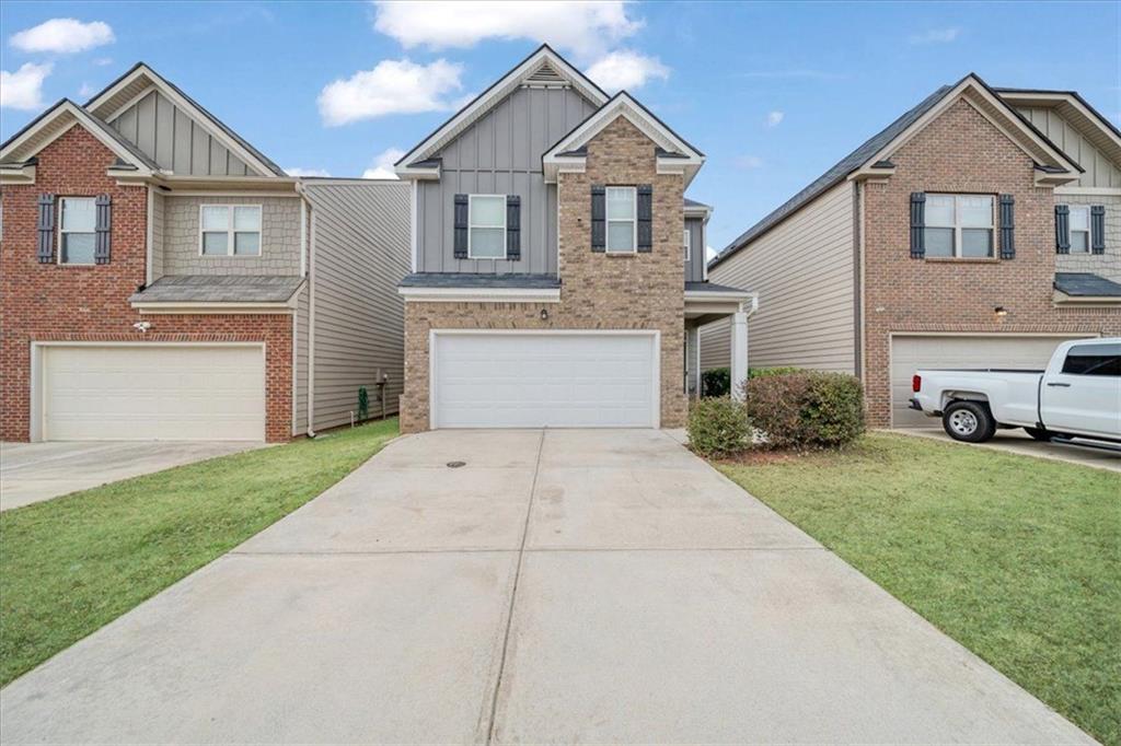 a front view of a house with a yard and garage