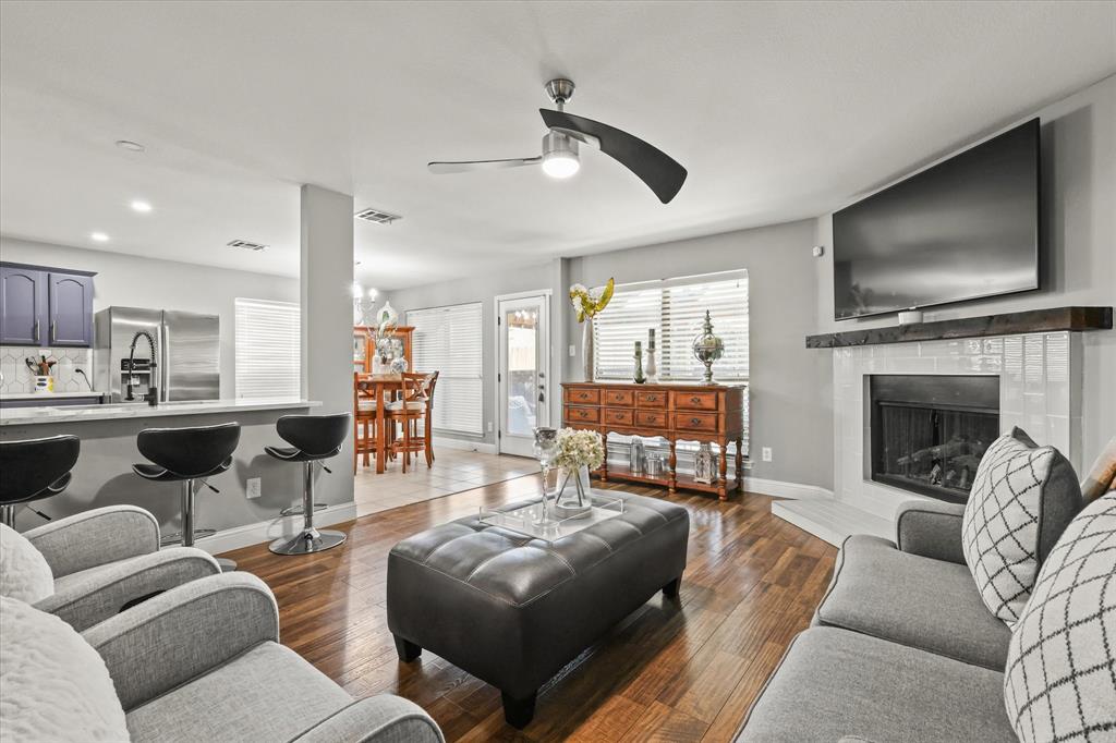 a living room with furniture fireplace and flat screen tv