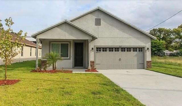 a front view of a house with a yard and garage