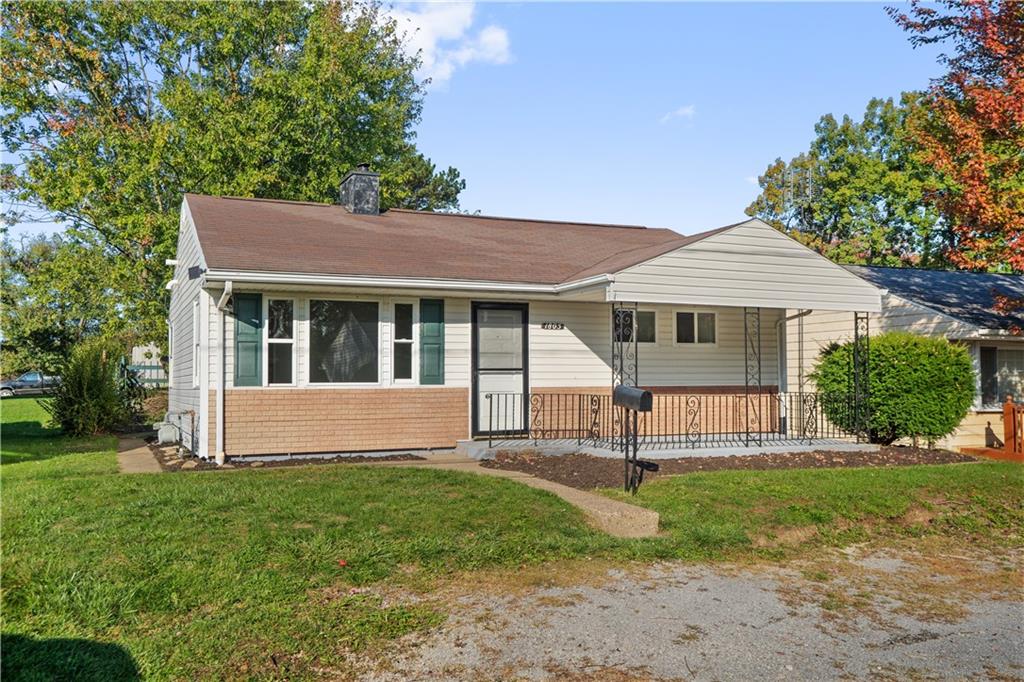 a view of house with a yard