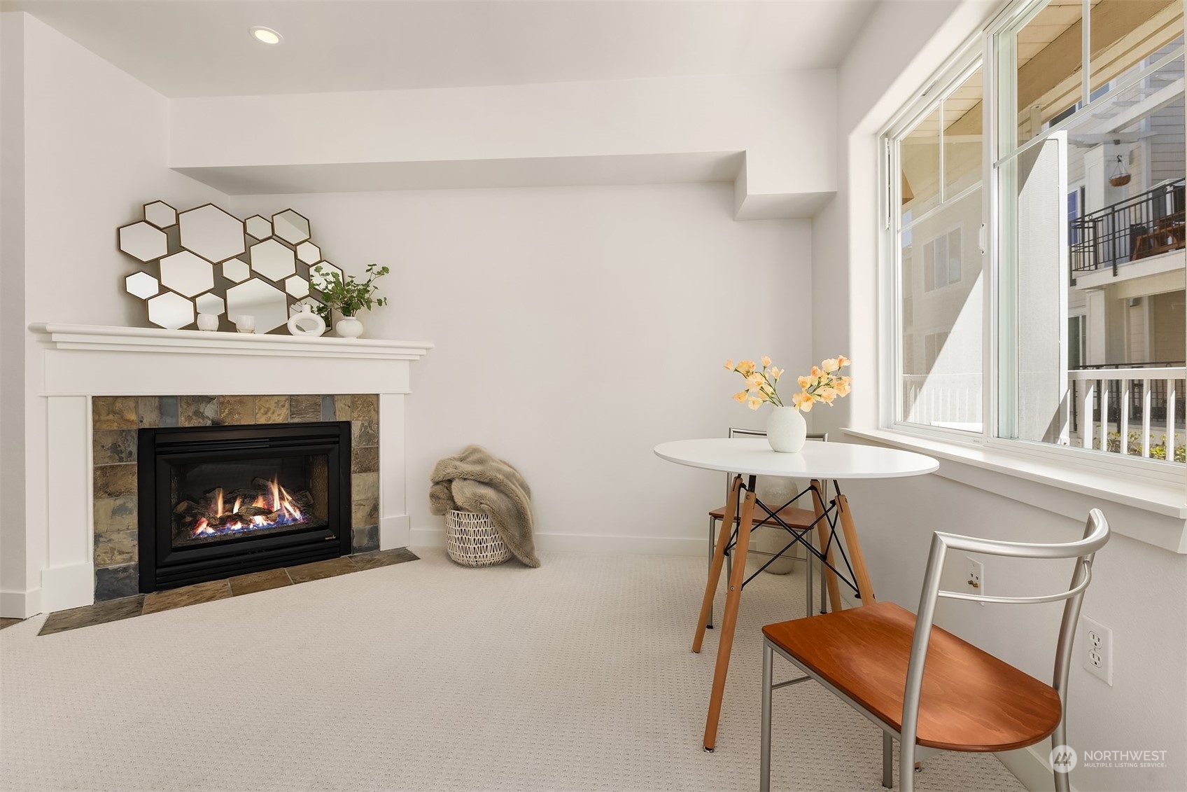 a living room with furniture a fireplace and a table