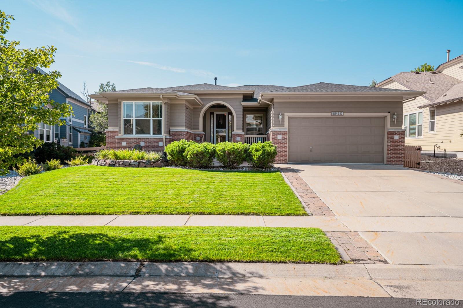 a front view of a house with a garden