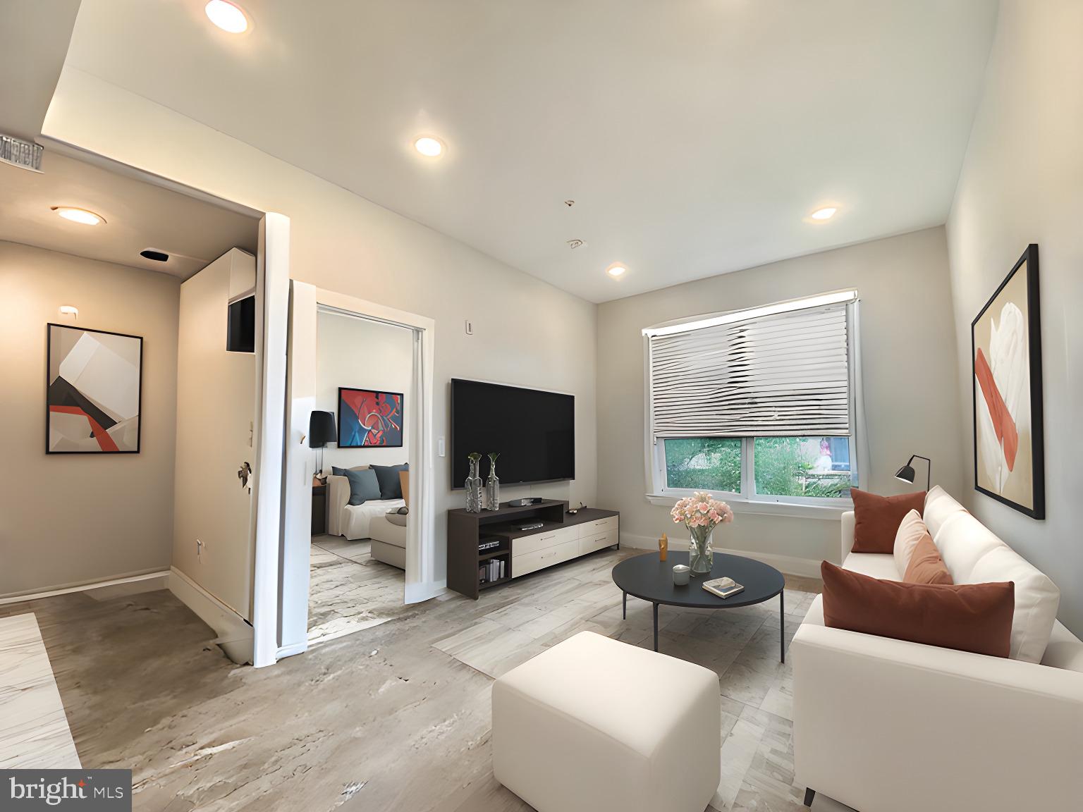 a living room with furniture and a flat screen tv