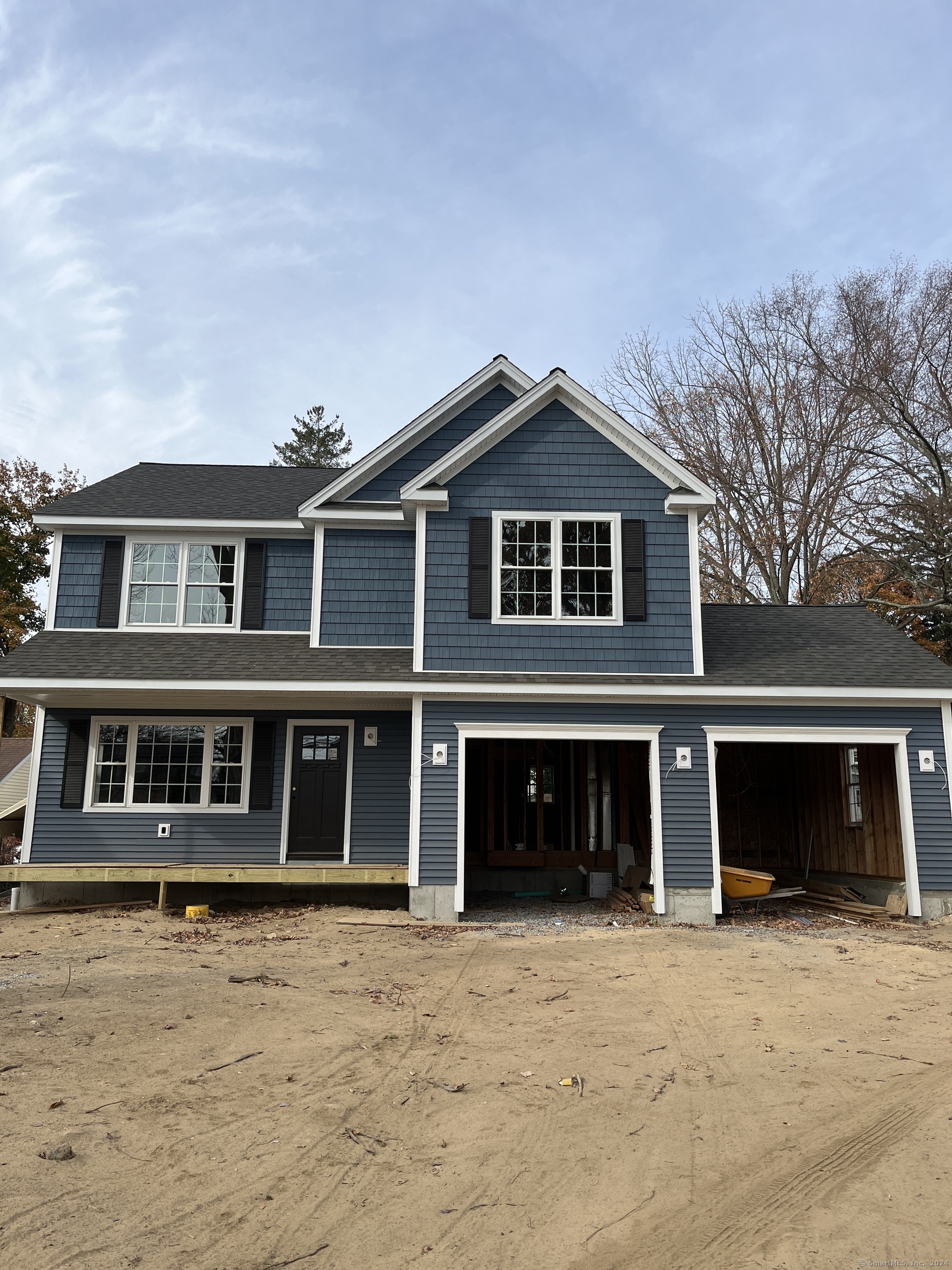 a front view of a house with a yard and parking space