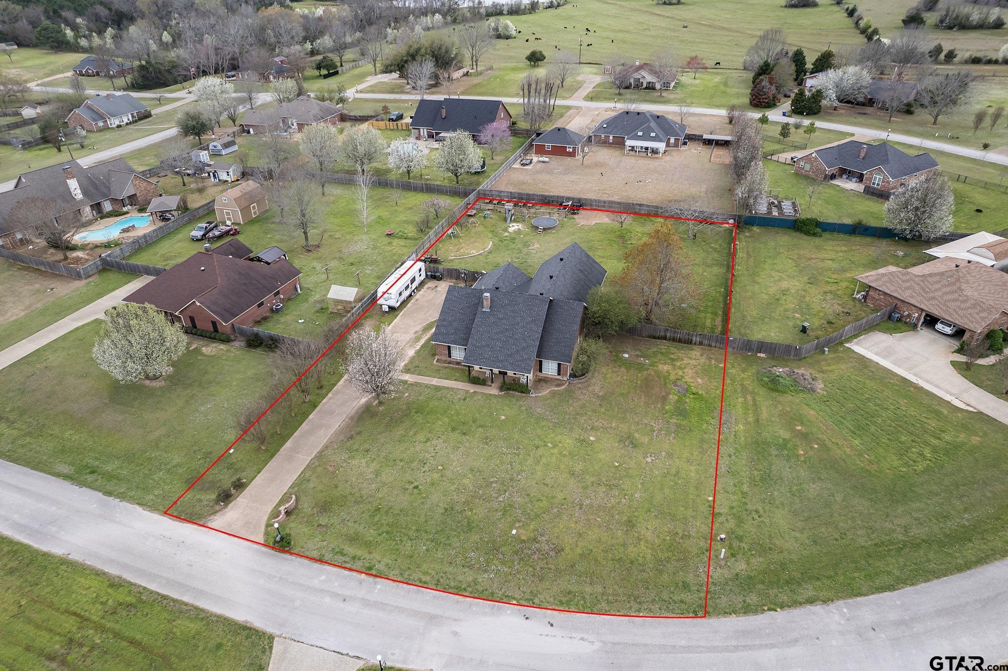 an aerial view of a house with a yard