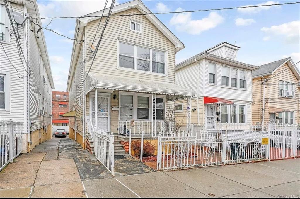 a view of a house with a small backyard