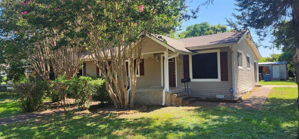 a view of house with backyard and garden