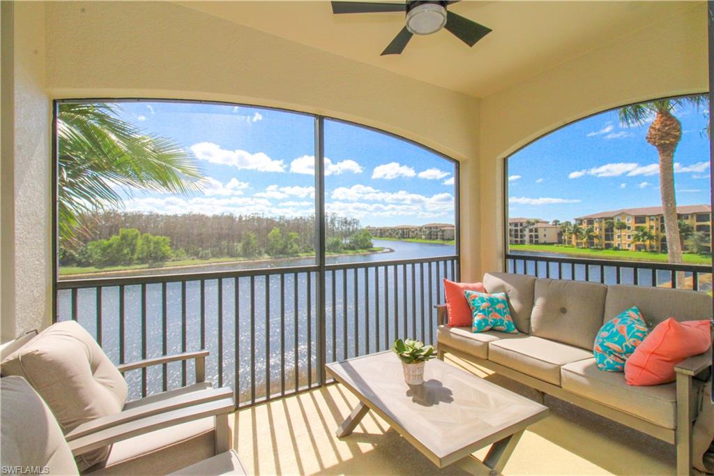 a balcony with furniture and a floor to ceiling window