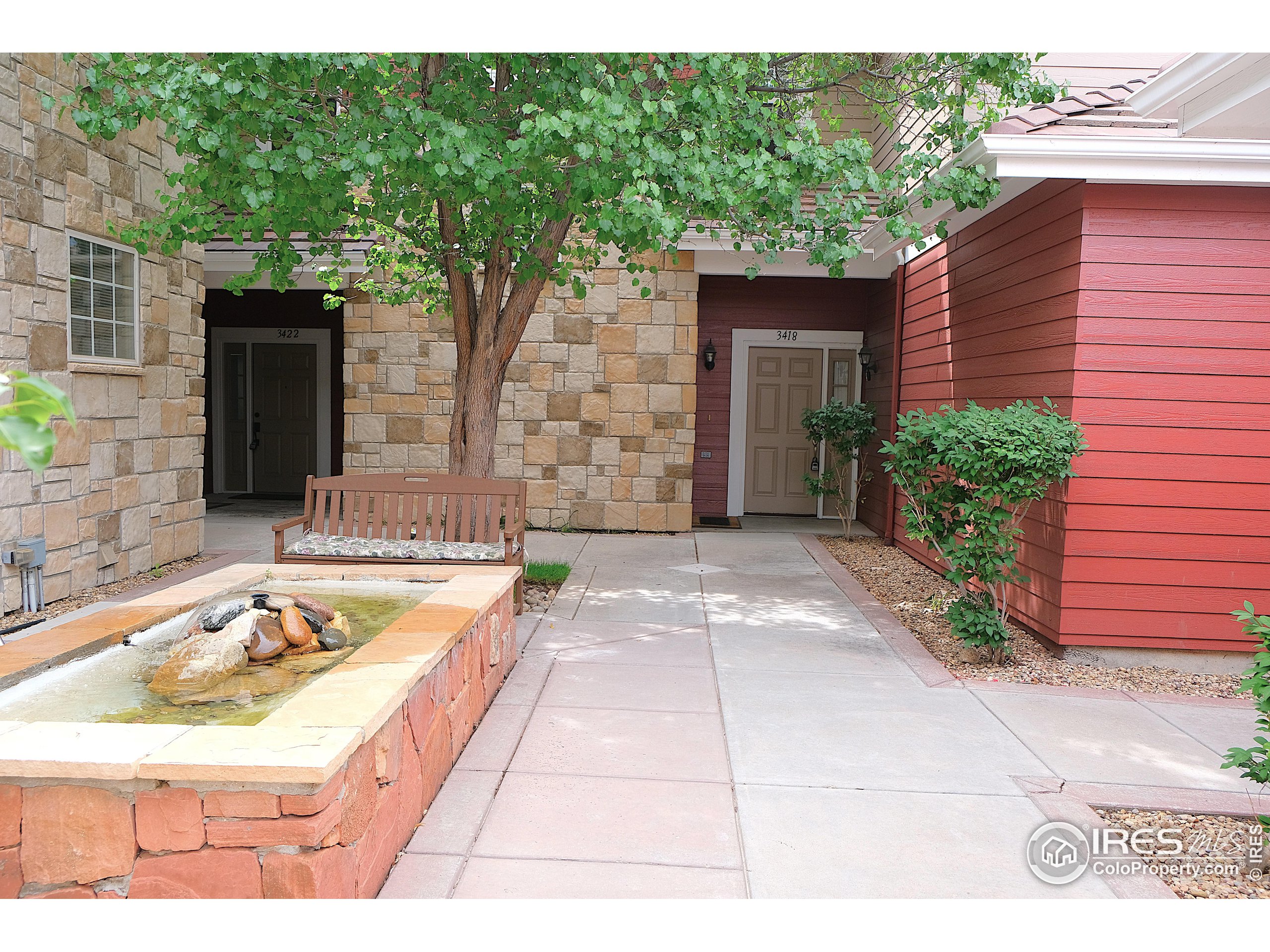 a view of a house with backyard and sitting area