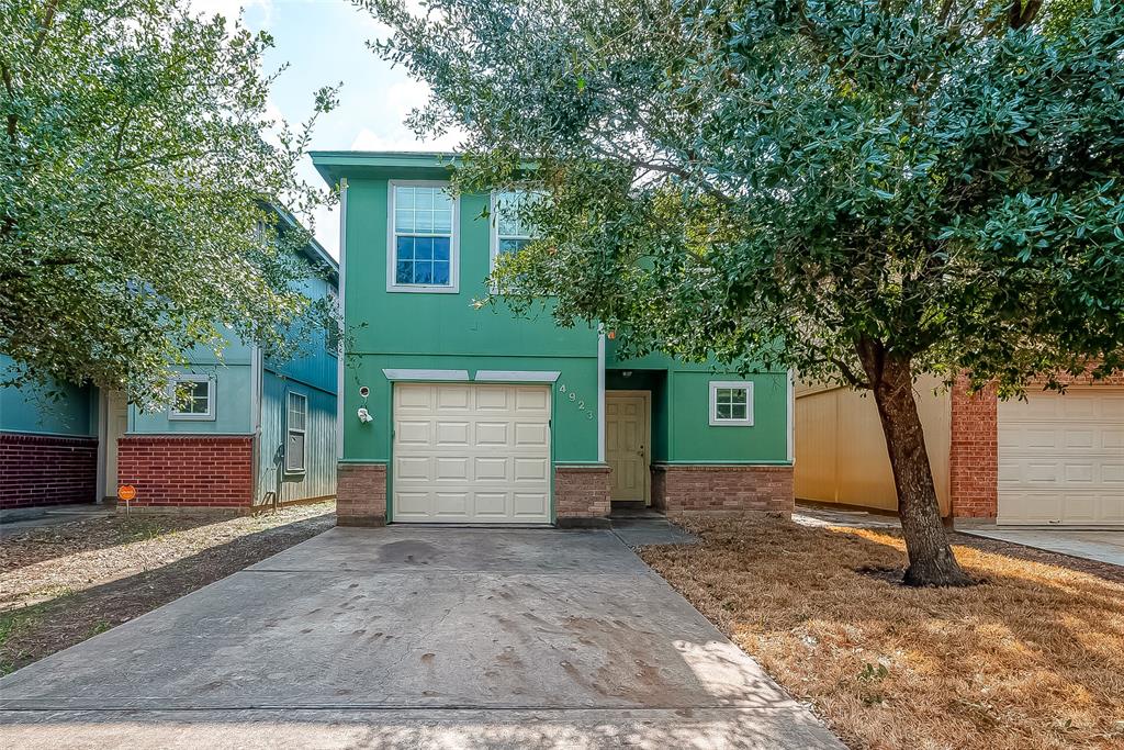 a view of a house with a yard and garage